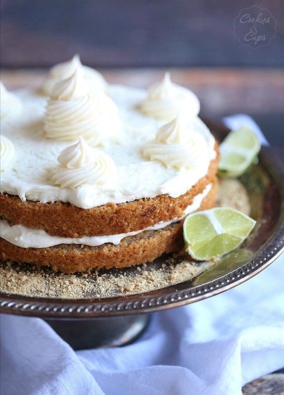 Frosted key lime pie layer cake on a cake stand.