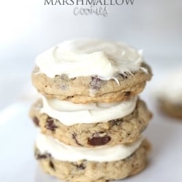 3 stacked chocolate chip marshmallow cookies with cream cheese frosting