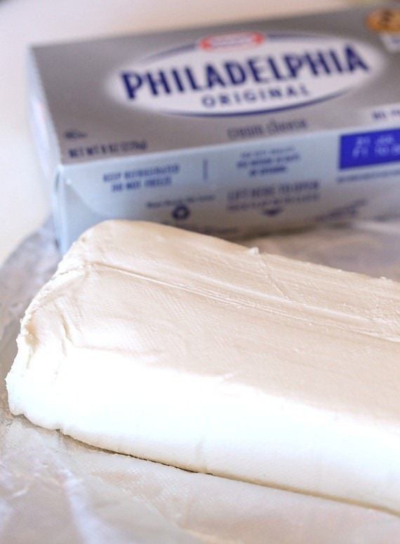 Close up of a softened brick of Philadelphia cream cheese.