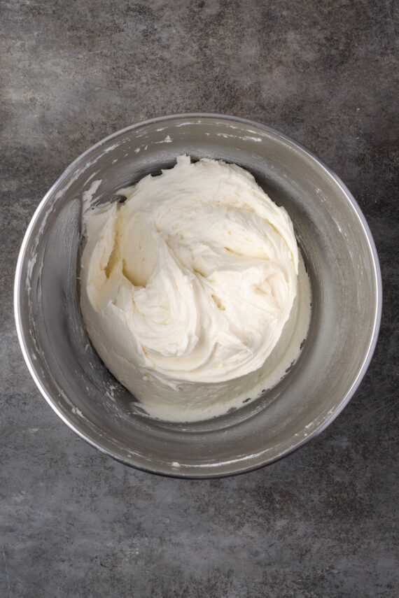 Coconut buttercream frosting in a mixing bowl.