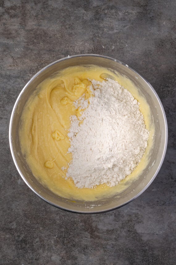 Dry ingredients added to wet ingredients in a mixing bowl.