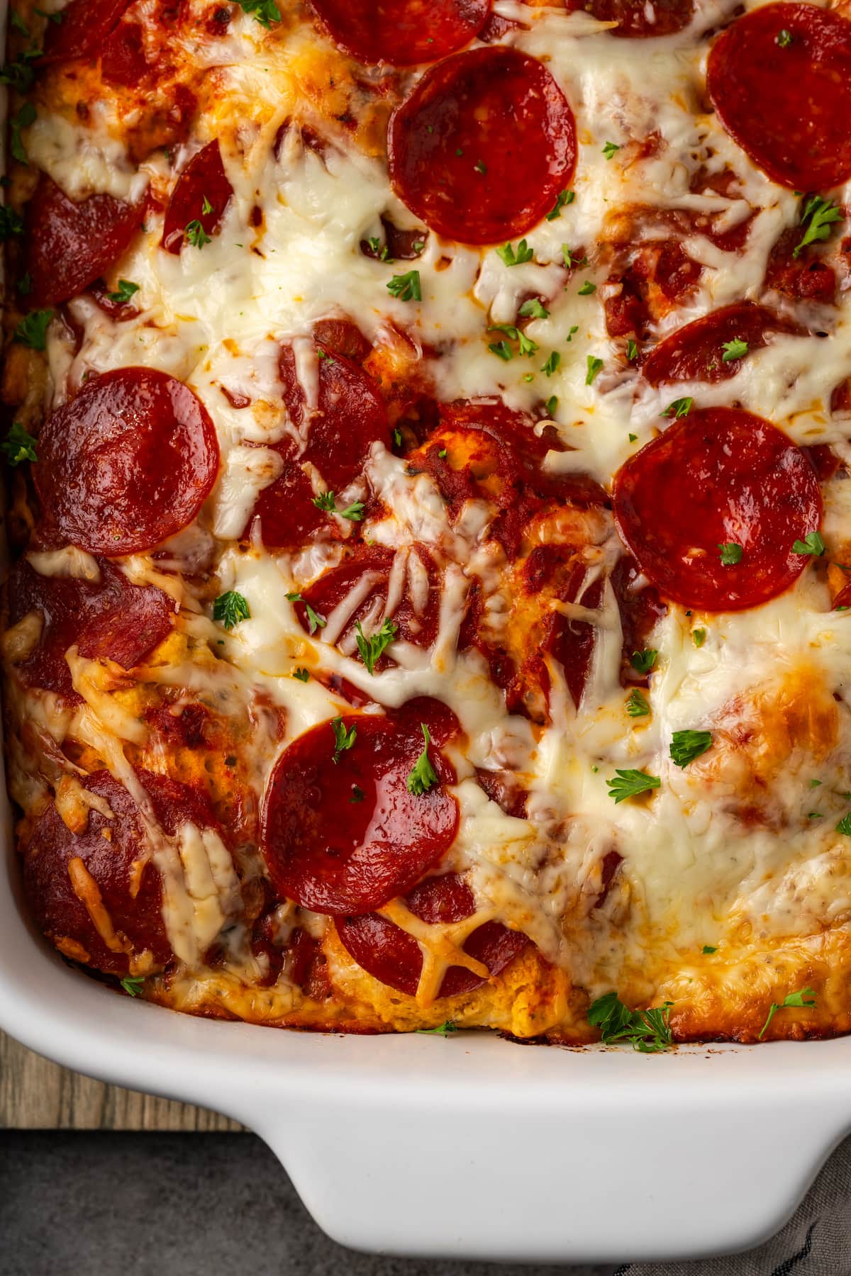 Overhead view of pizza casserole in a baking dish.