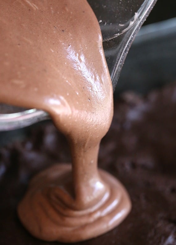 Topping the base with a chocolate cream cheese mixture!