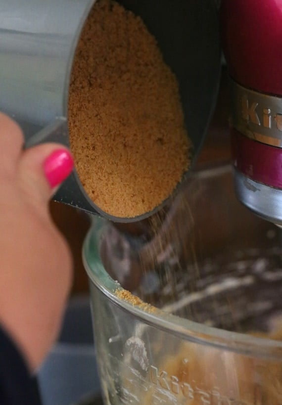 Pouring Graham cracker crumbs into the cookie dough