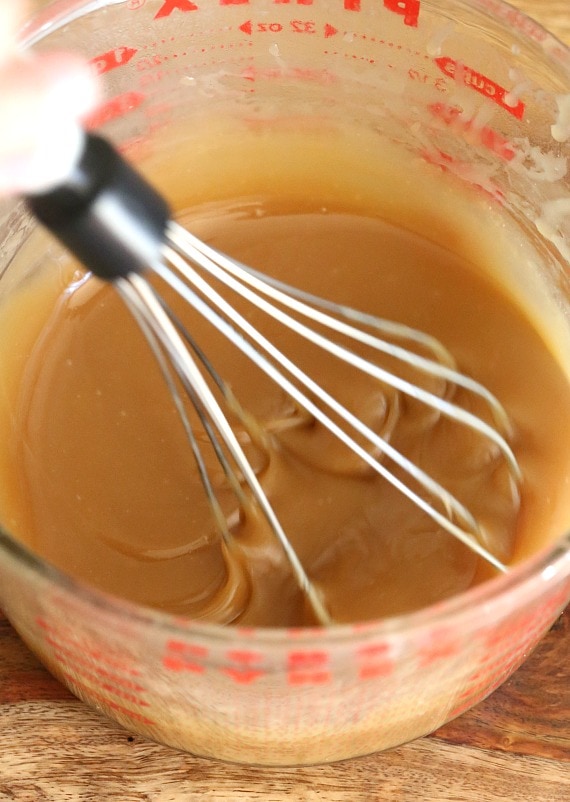 Whisking the sauce in a measuring cup