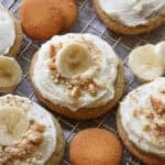 Banana Pudding Cookies with creamy frosting and crushed Nilla Wafers and a slice of banana