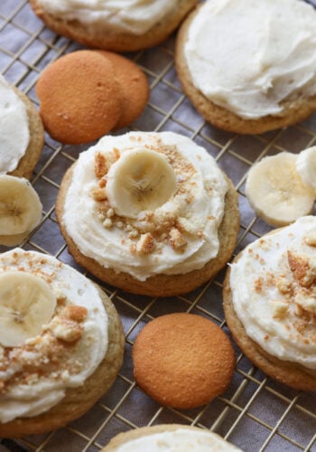 Banana Pudding Cookies with creamy frosting and crushed Nilla Wafers and a slice of banana