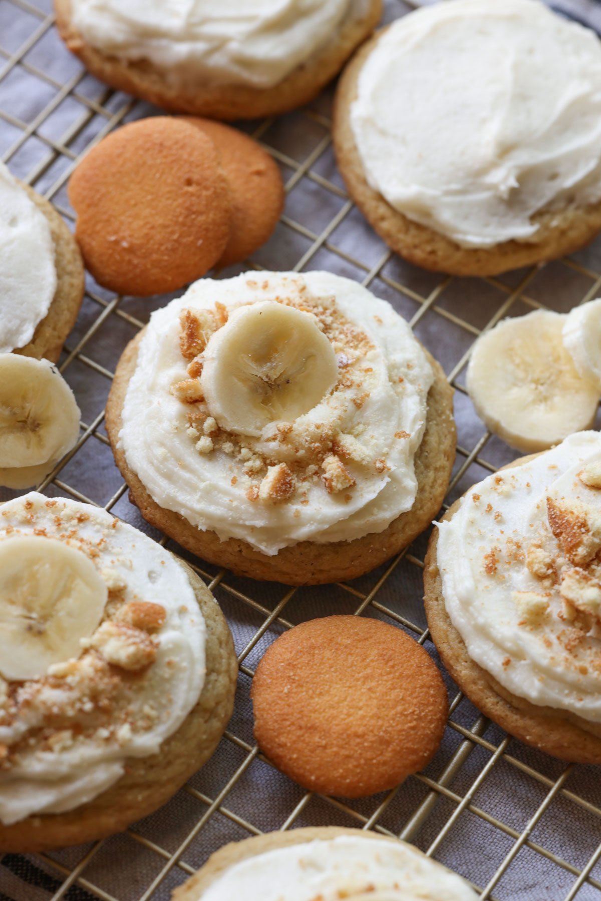 Banana Pudding Cookies with creamy frosting and crushed Nilla Wafers and a slice of banana