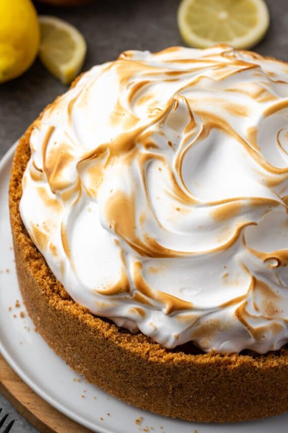 Overhead view of lemon meringue cheesecake with a toasted top on a plate.