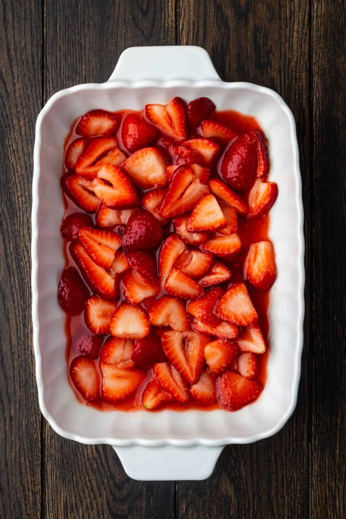 Strawberry filling spread inside a ceramic baking dish.