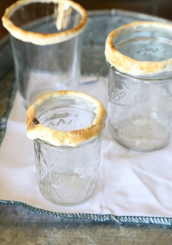 Dip each glass into marshmallow fluff and then toast it using a kitchen torch!