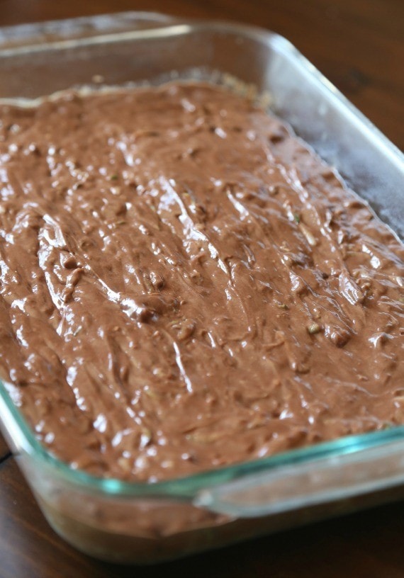 Chocolate zucchini cake batter in a glass baking dish.