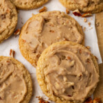 Pecan praline cookies on a parchment-lined wooden board.