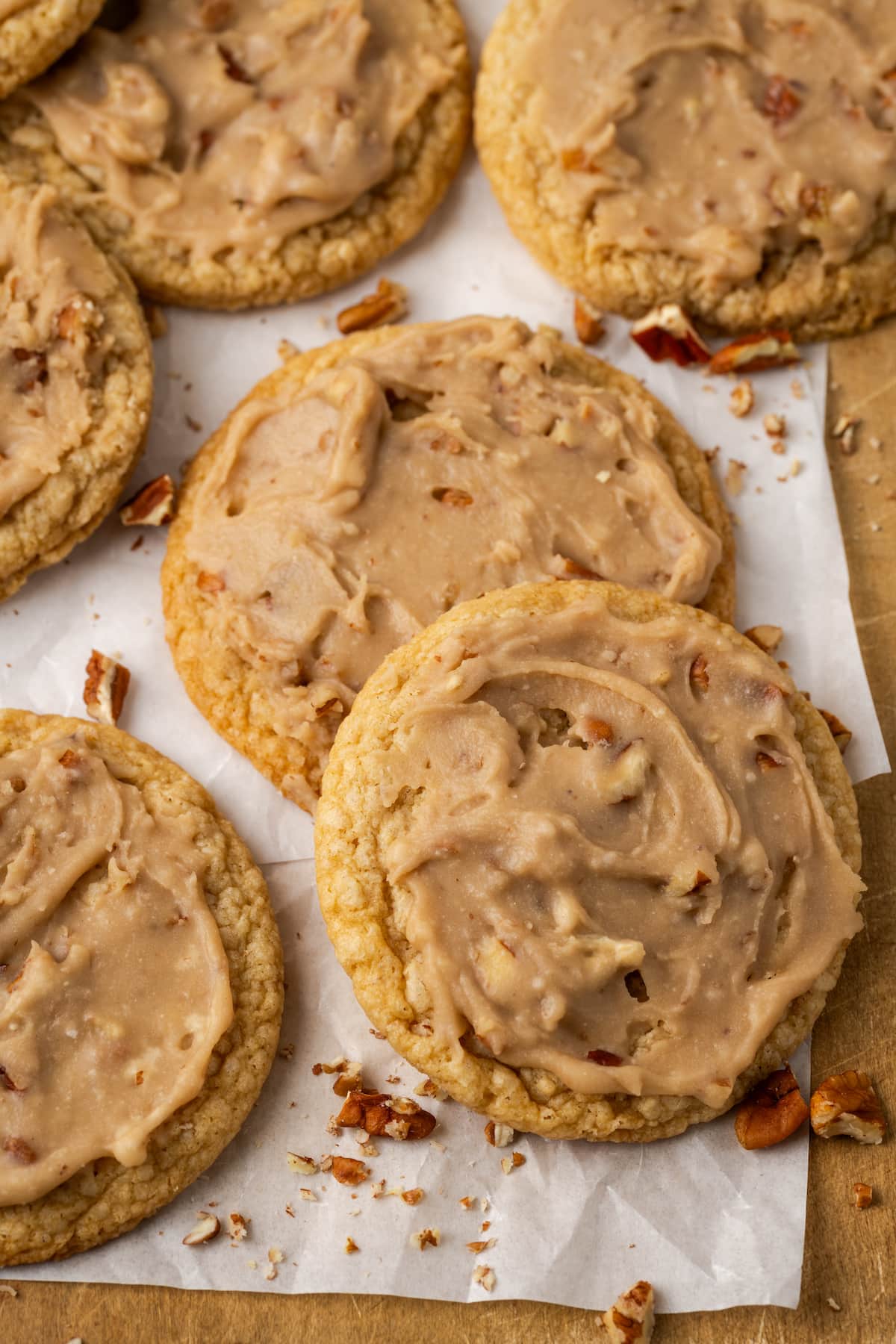 Pecan praline cookies on a parchment-lined wooden board.