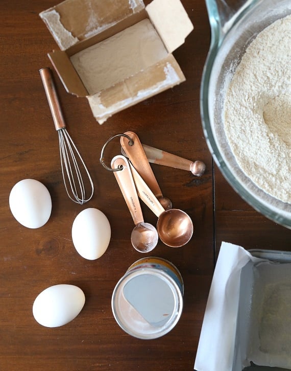 3 eggs, measuring spoons and other ingredients for blueberry bread.