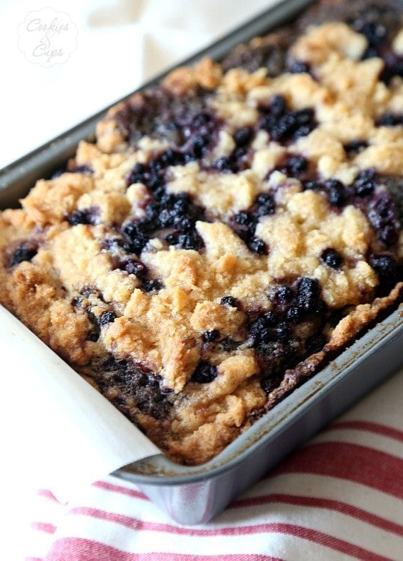 Baked blueberry bread in a parchment-lined loaf pan.