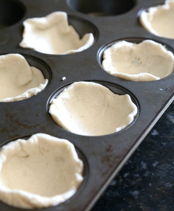 Biscuit dough pressed into muffin tins
