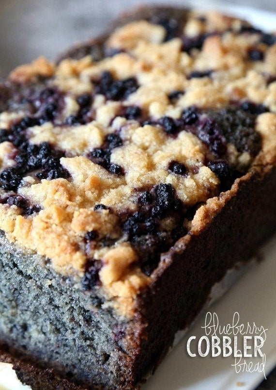 A loaf of blueberry cobbler bread sliced open