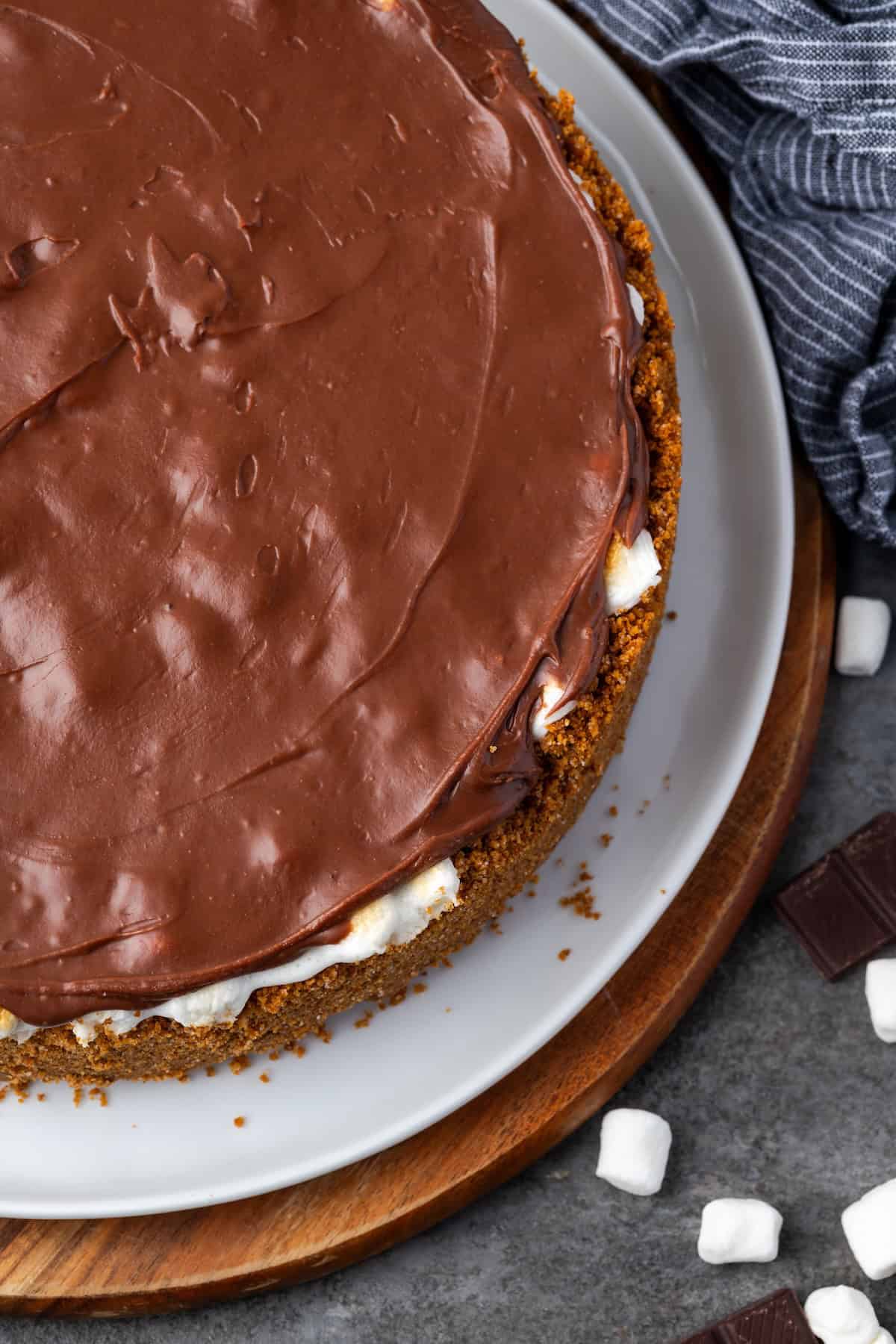 Overhead view of brownie pie topped with chocolate frosting on a plate.