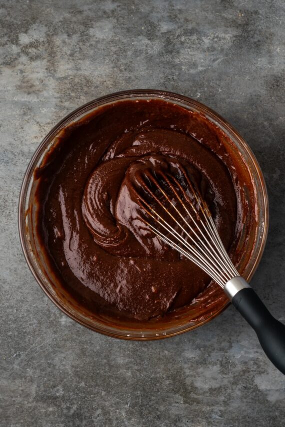Brownie pie filling in a bowl with a whisk.