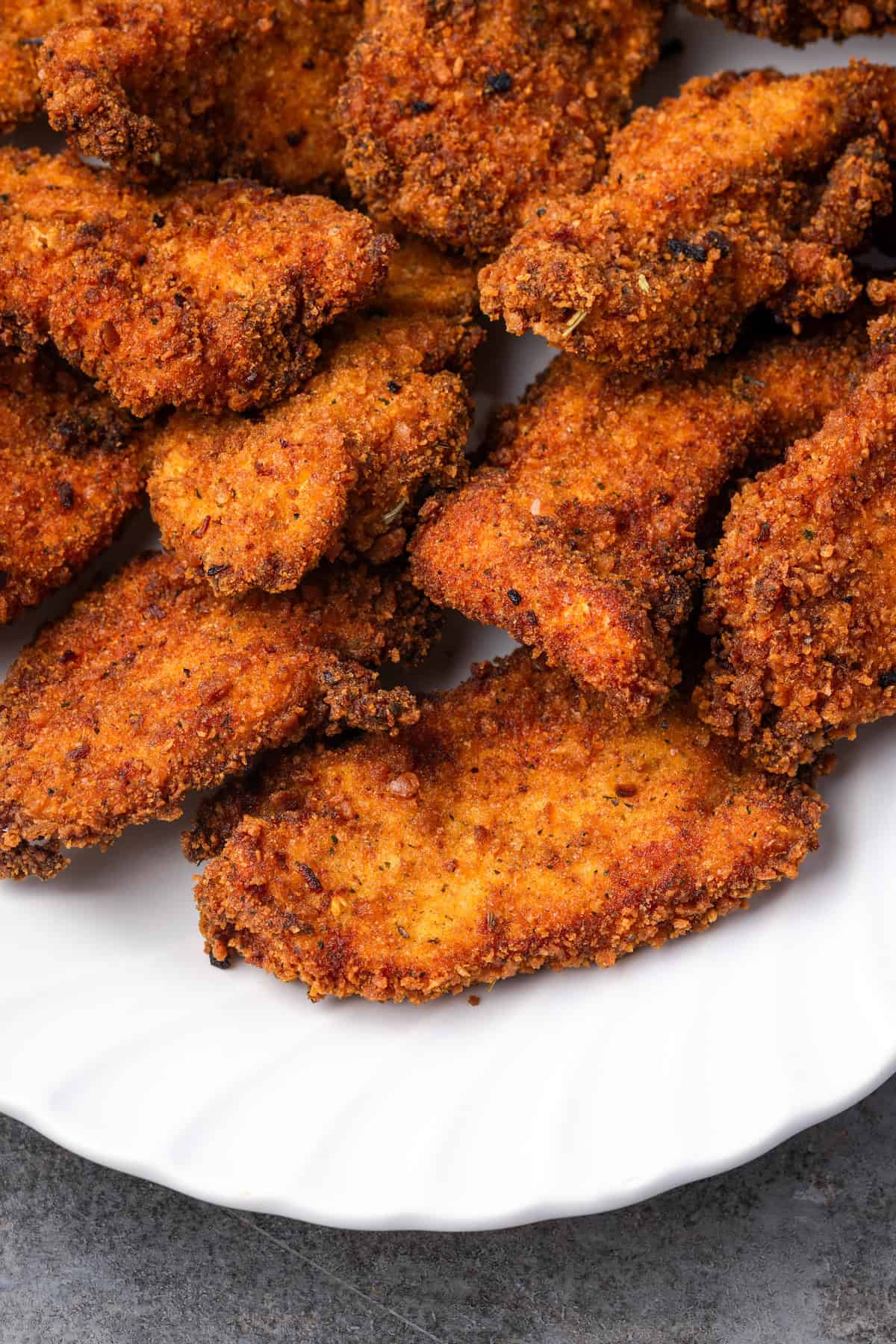 Close up of a platter of crispy chicken stuffing chicken tenders.