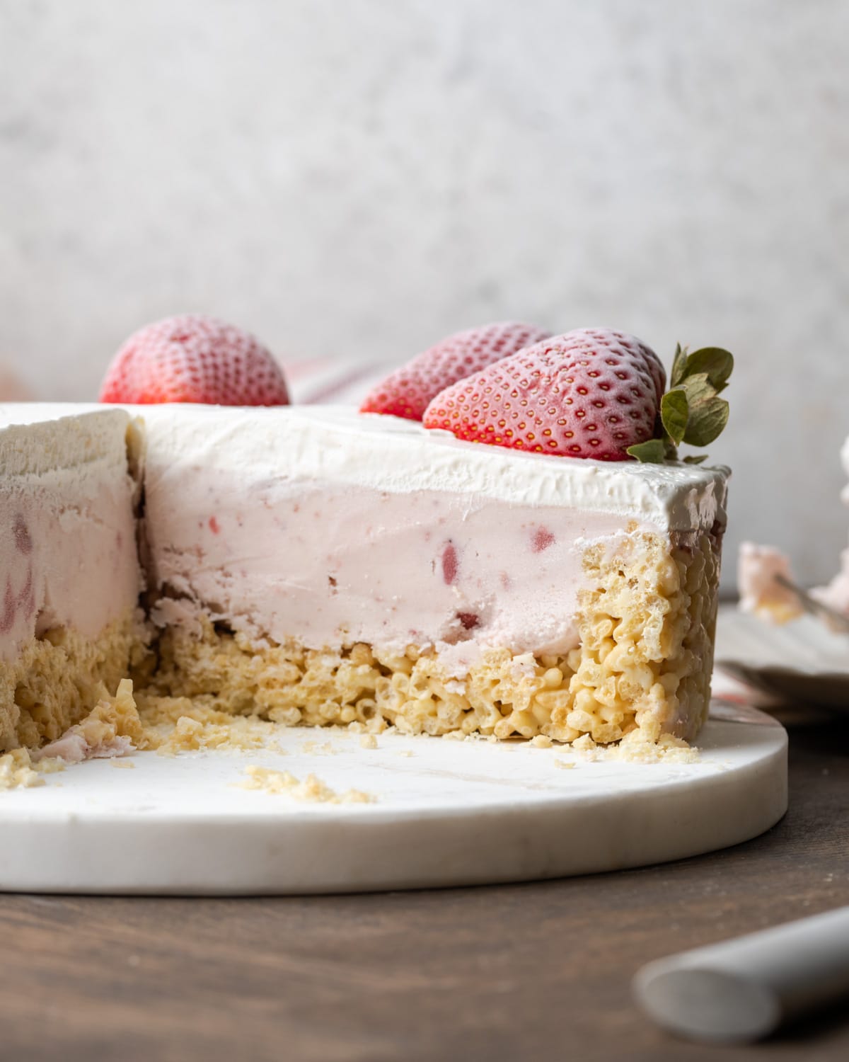 Krispie Treat ice cream pie on a platter with slices missing.