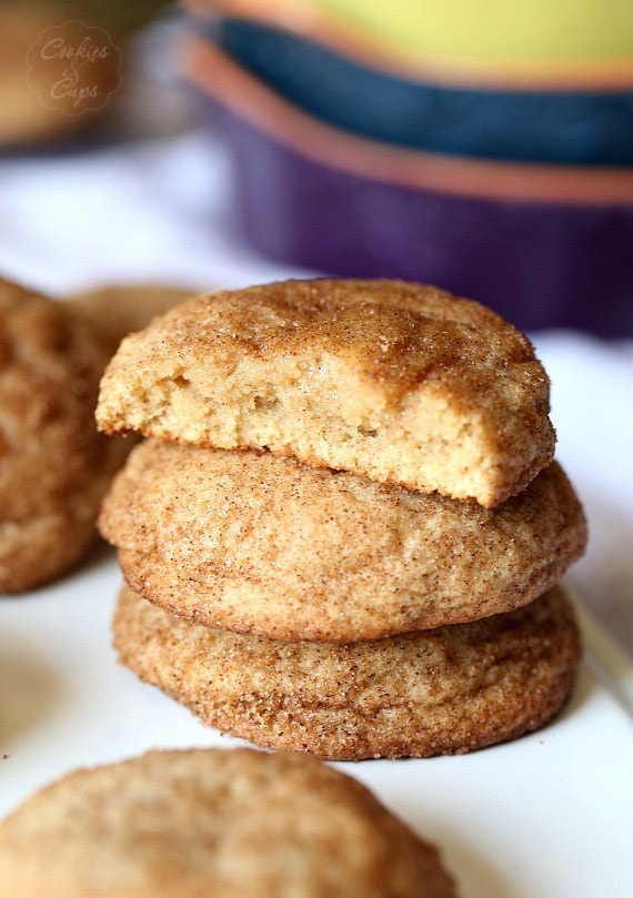 Stacked cookies coated in pumpkin spice and sugar, one with a bite missing