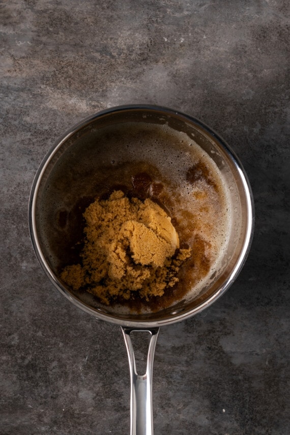 Brown sugar added to browned butter in a saucepan.