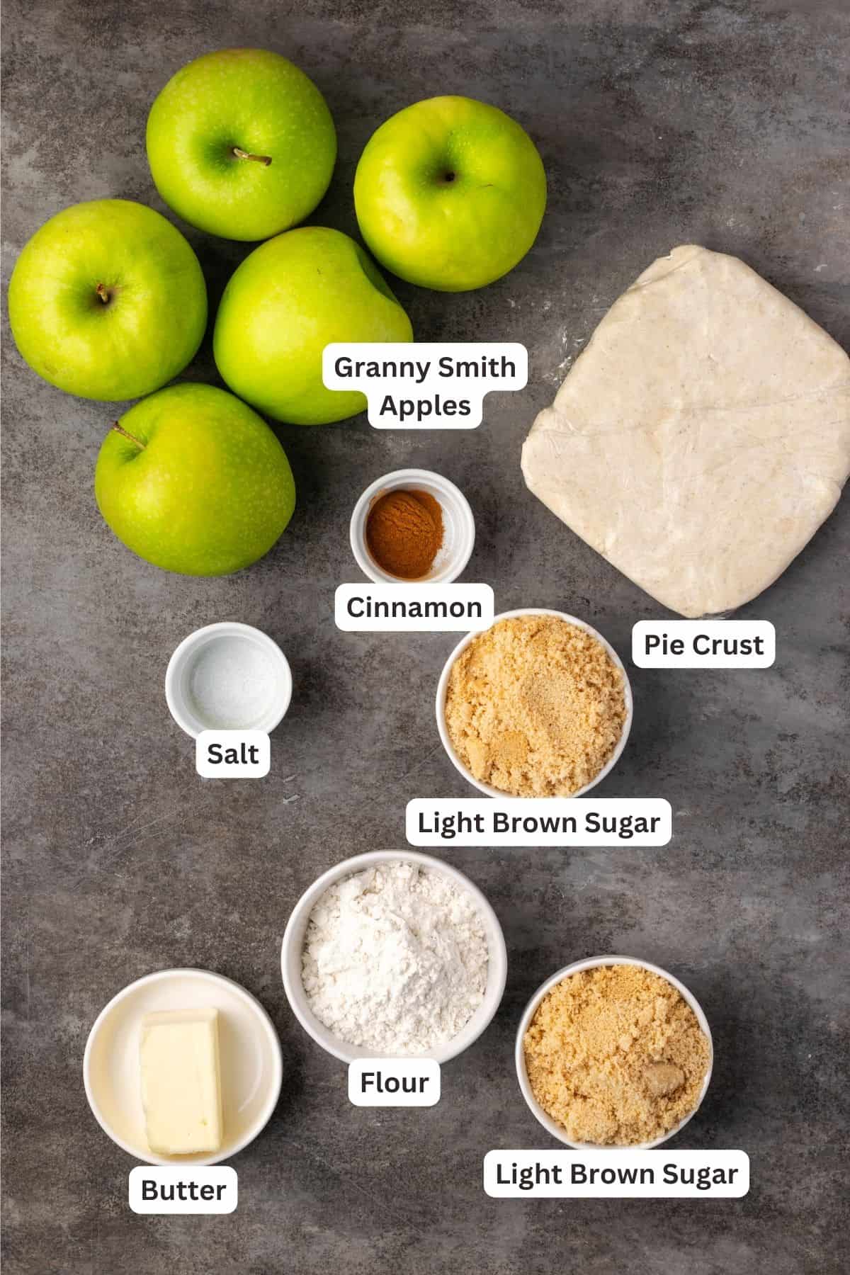 Ingredients for an apple crumble tart with text labels overlaying each ingredient.