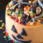 SIMPLE Halloween Candy Cake...SImply frost a cake with orange frosting, draw on a Jack O Lantern face and top with candy!!