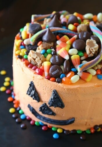 SIMPLE Halloween Candy Cake...SImply frost a cake with orange frosting, draw on a Jack O Lantern face and top with candy!!