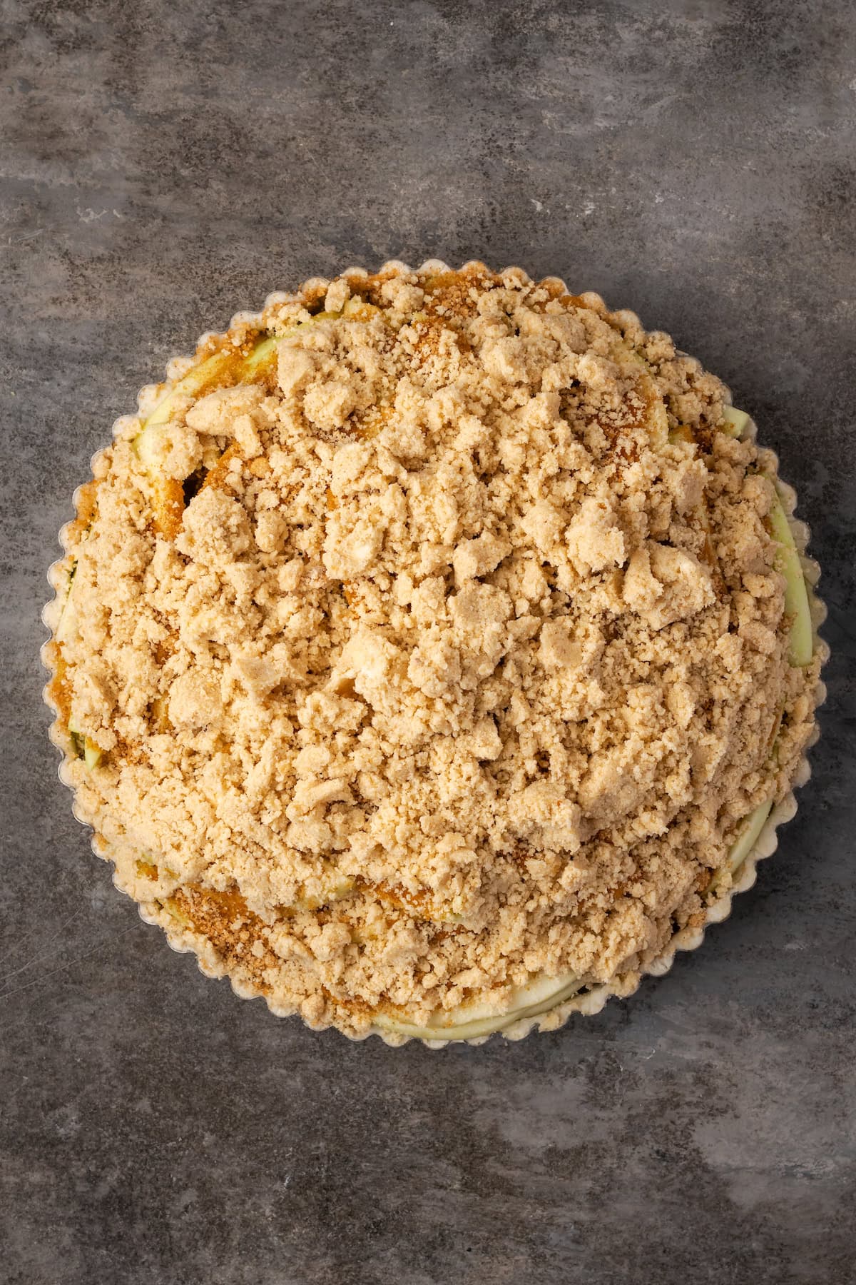 The crumble topping added to an apple tart.