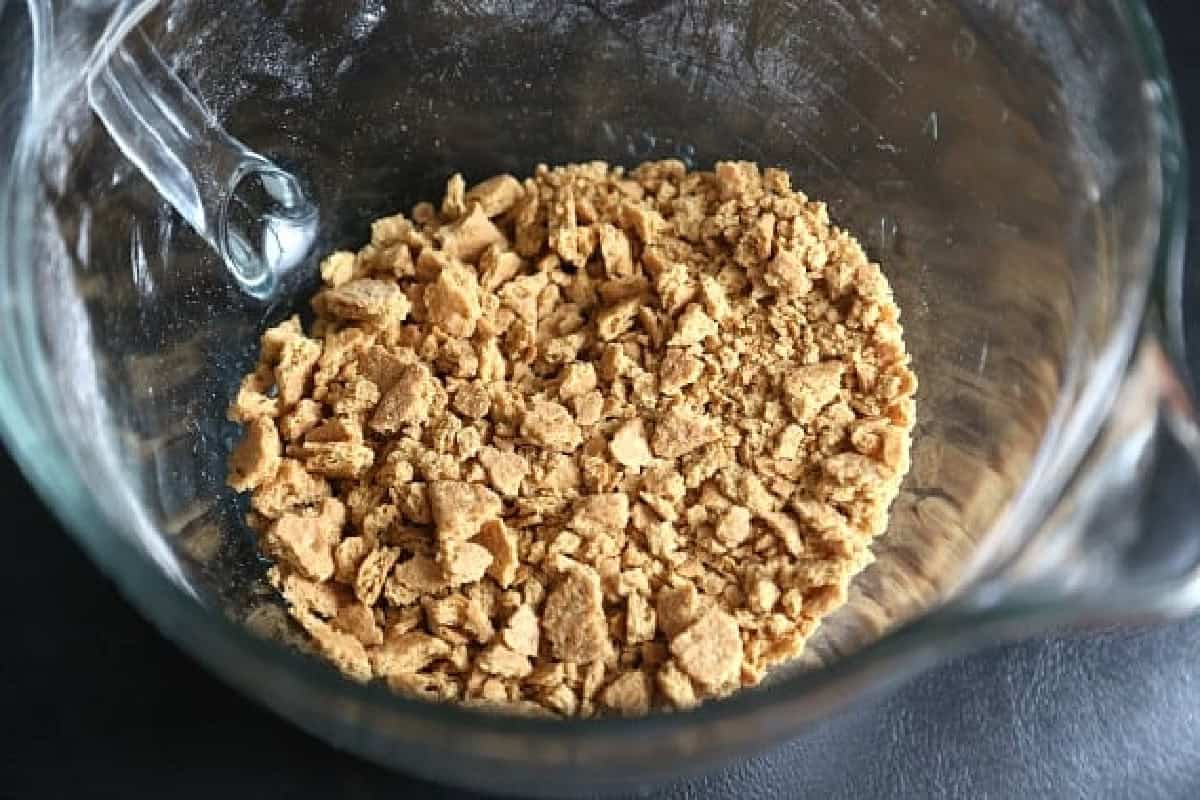 Crushed graham crackers in a glass bowl