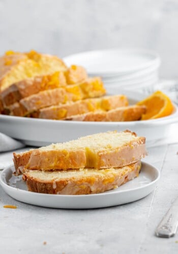 Orange pound cake slices on a plate.