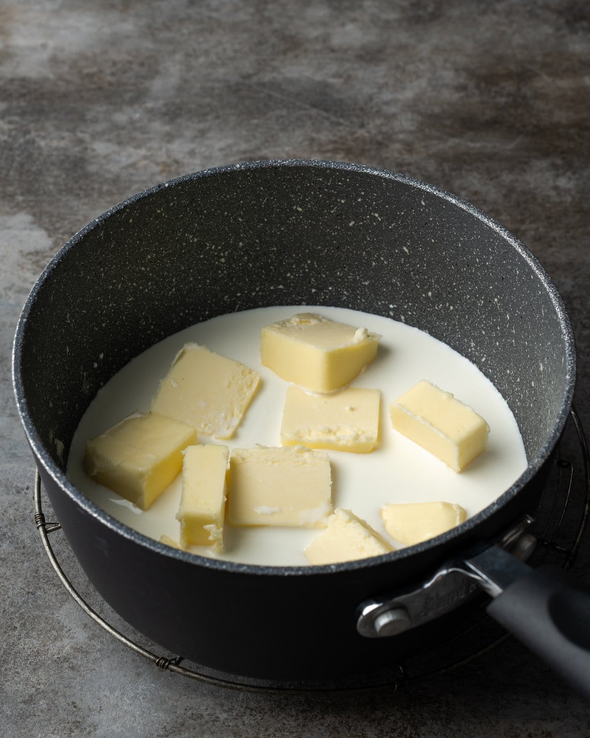 Butter added to a pot with whole milk..