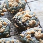 Soft blueberry cookies on a wire rack topped with streusel crumble.