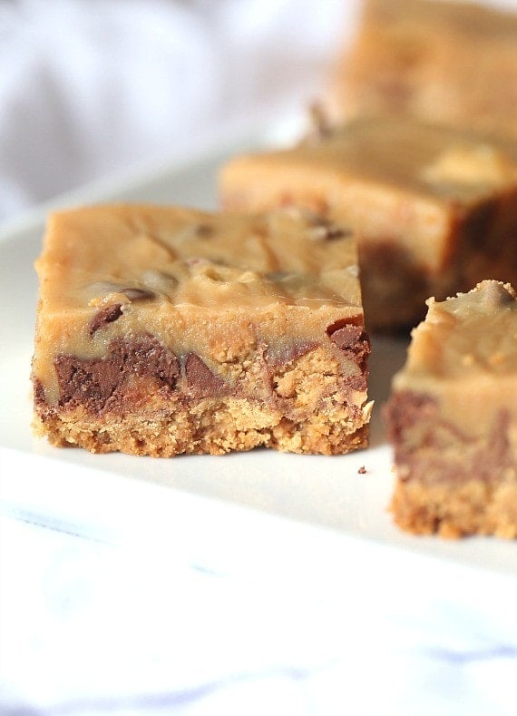 Outrageous Peanut Butter Candy Bars ~ These bars have a Nutter Butter Crust, chopped Reeses Cups, Chopped Butterfinger, peanut butter chips and chocolate chips, all topped with a creamy layer of sweetened condensed milk and peanut butter! OMG!!