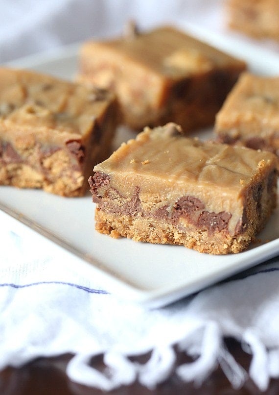 Outrageous Peanut Butter Candy Bars ~ These bars have a Nutter Butter Crust, chopped Reeses Cups, Chopped Butterfinger, peanut butter chips and chocolate chips, all topped with a creamy layer of sweetened condensed milk and peanut butter! OMG!!