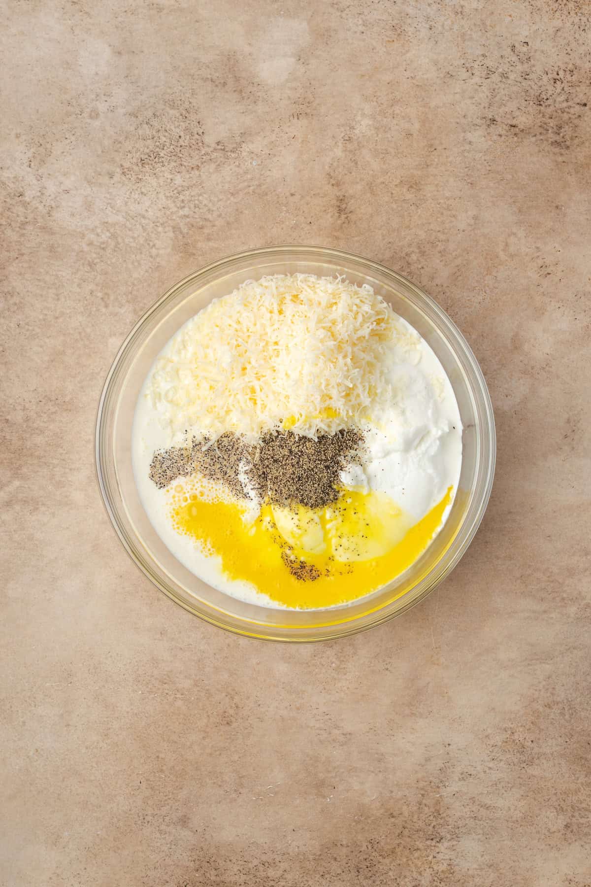 Ricotta and parmesan mixture combined in a bowl.