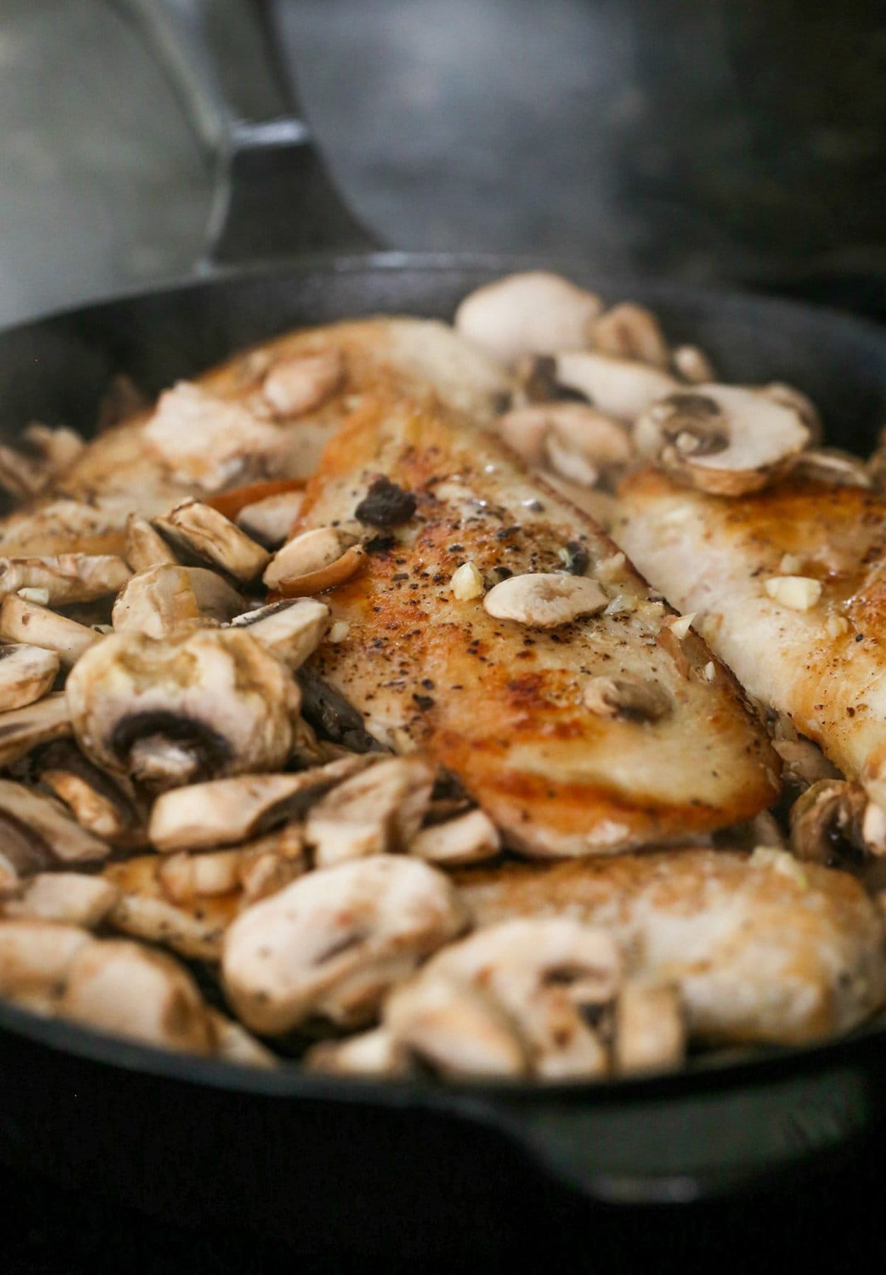 Mushrooms and chicken cooked in a skillet
