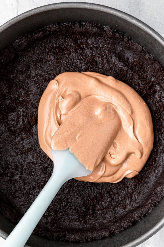 Chocolate filling being spread over the Oreo crust.