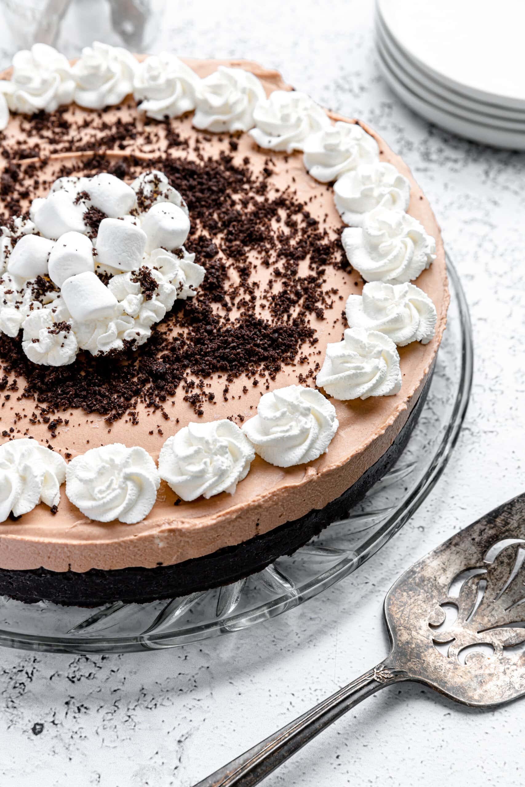 A no bake chocolate pie with whipped cream and an Oreo crust