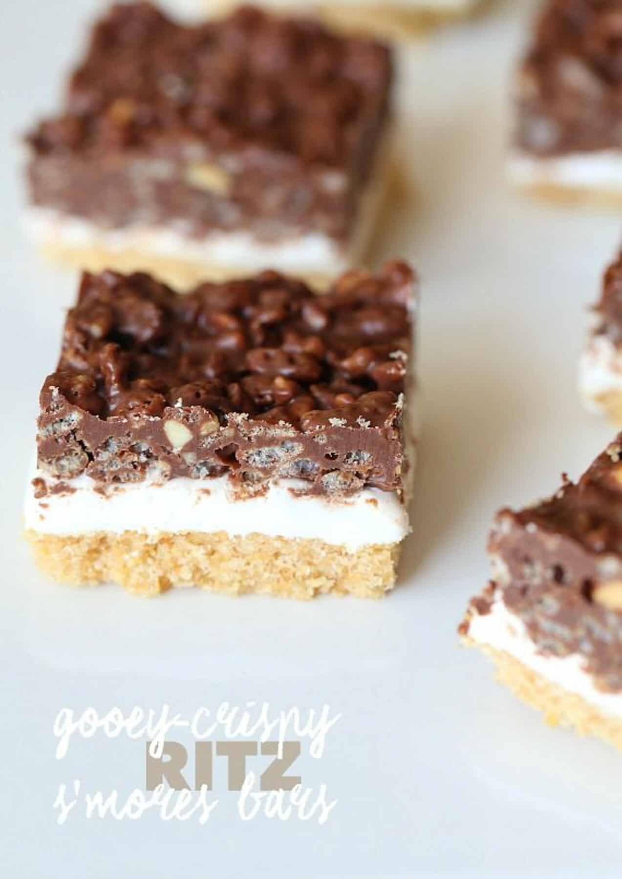 Gooey Crispy Ritz S'mores Bars! These are so crazy delicious...AND they are no bake! The creamy Fluff in between a layer of crispy, buttery Ritz Crackers and Crunchy peanut butter chocolate!