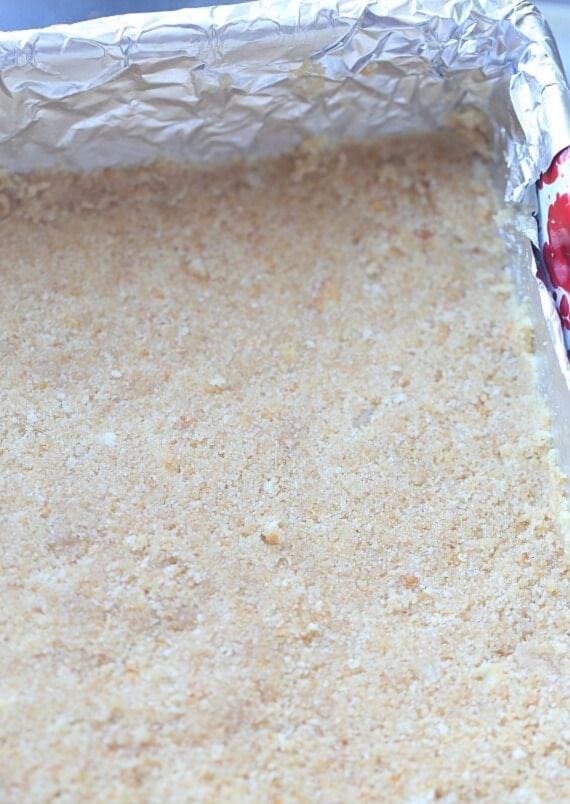 These s’mores bars layer a buttery Ritz cracker crust with gooey marshmallows and a chocolatey Rice Krispies treat topping. No oven required! Crushed crackers, butter, and sugar pressed into a 9x9 pan.