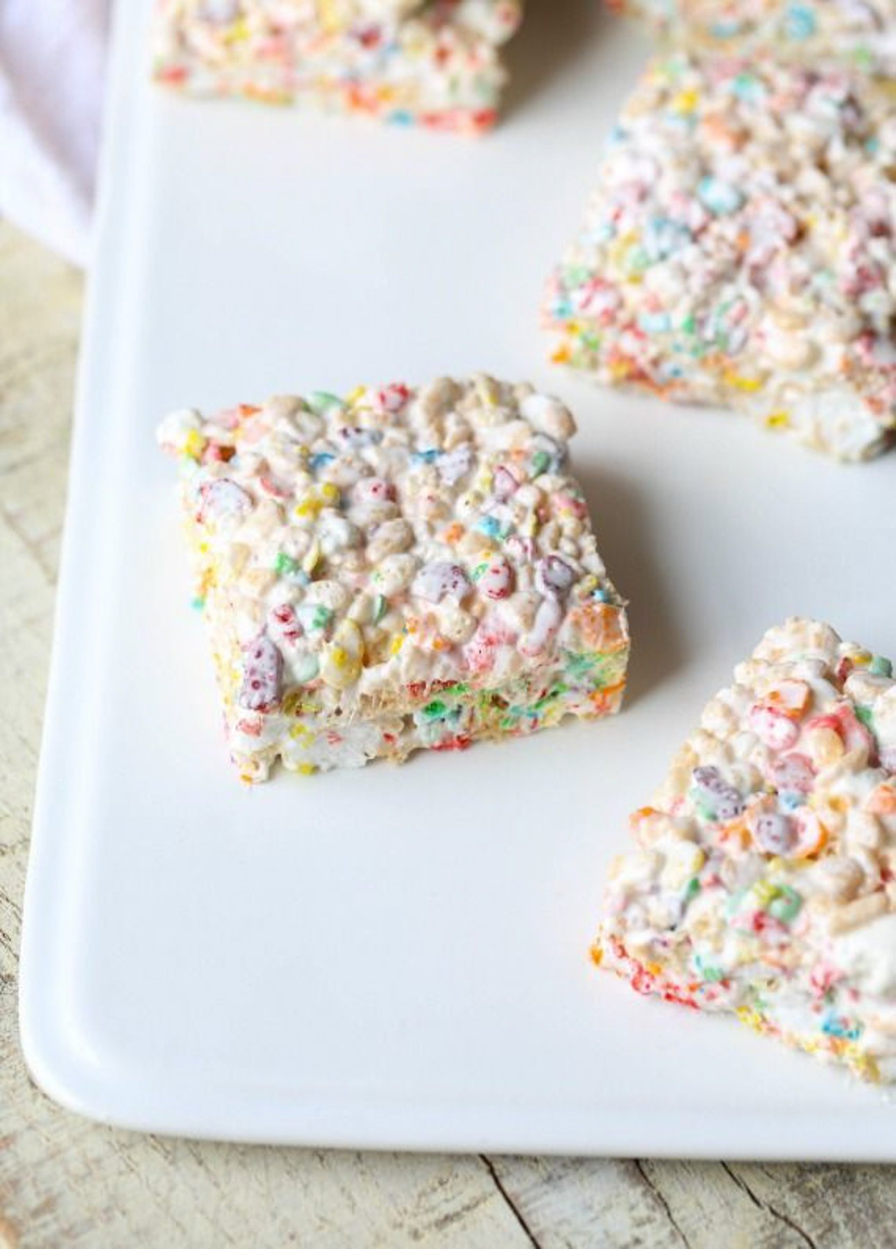 Krispie Treat squares made with Fluff and mini marshmallows on a platter