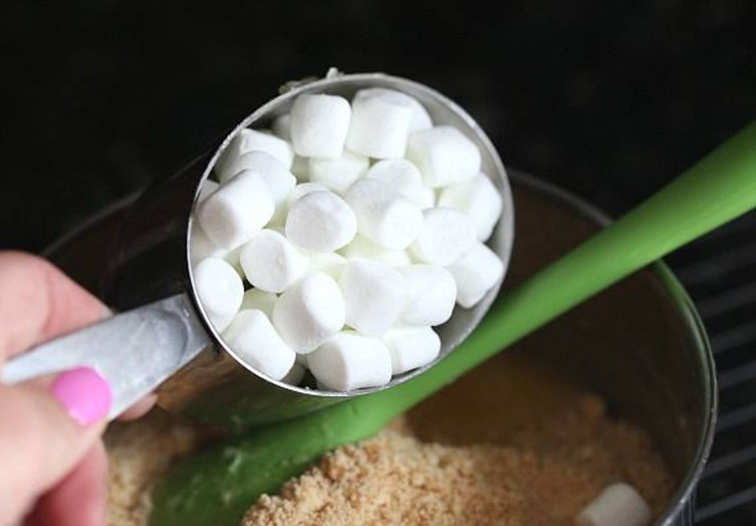 Marshmallows being added to coconut mix