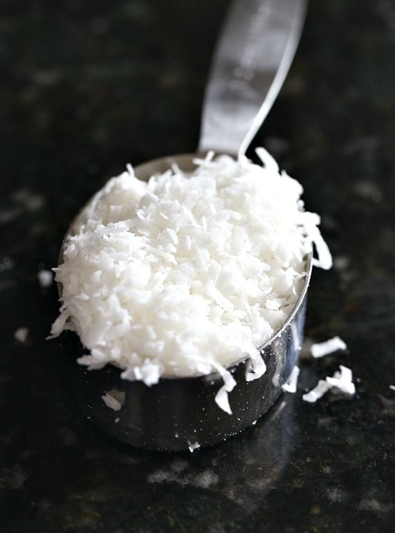 Coconut flakes in a measuring spoon