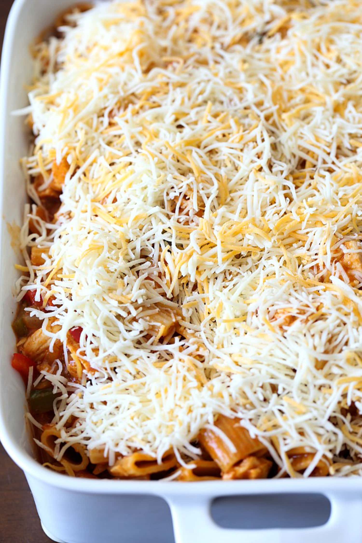 Enchilada Pasta in a 9x13 baking dish topped with grated cheese