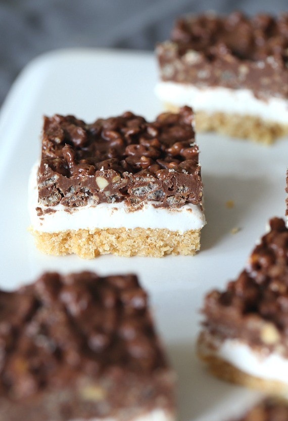 Gooey Crispy Ritz S'mores Bars! These are so crazy delicious...AND they are no bake! The creamy Fluff in between a layer of crispy, buttery Ritz Crackers and Crunchy peanut butter chocolate!