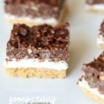 Gooey Crispy Ritz S'mores Bars! These are so crazy delicious...AND they are no bake! The creamy Fluff in between a layer of crispy, buttery Ritz Crackers and Crunchy peanut butter chocolate!